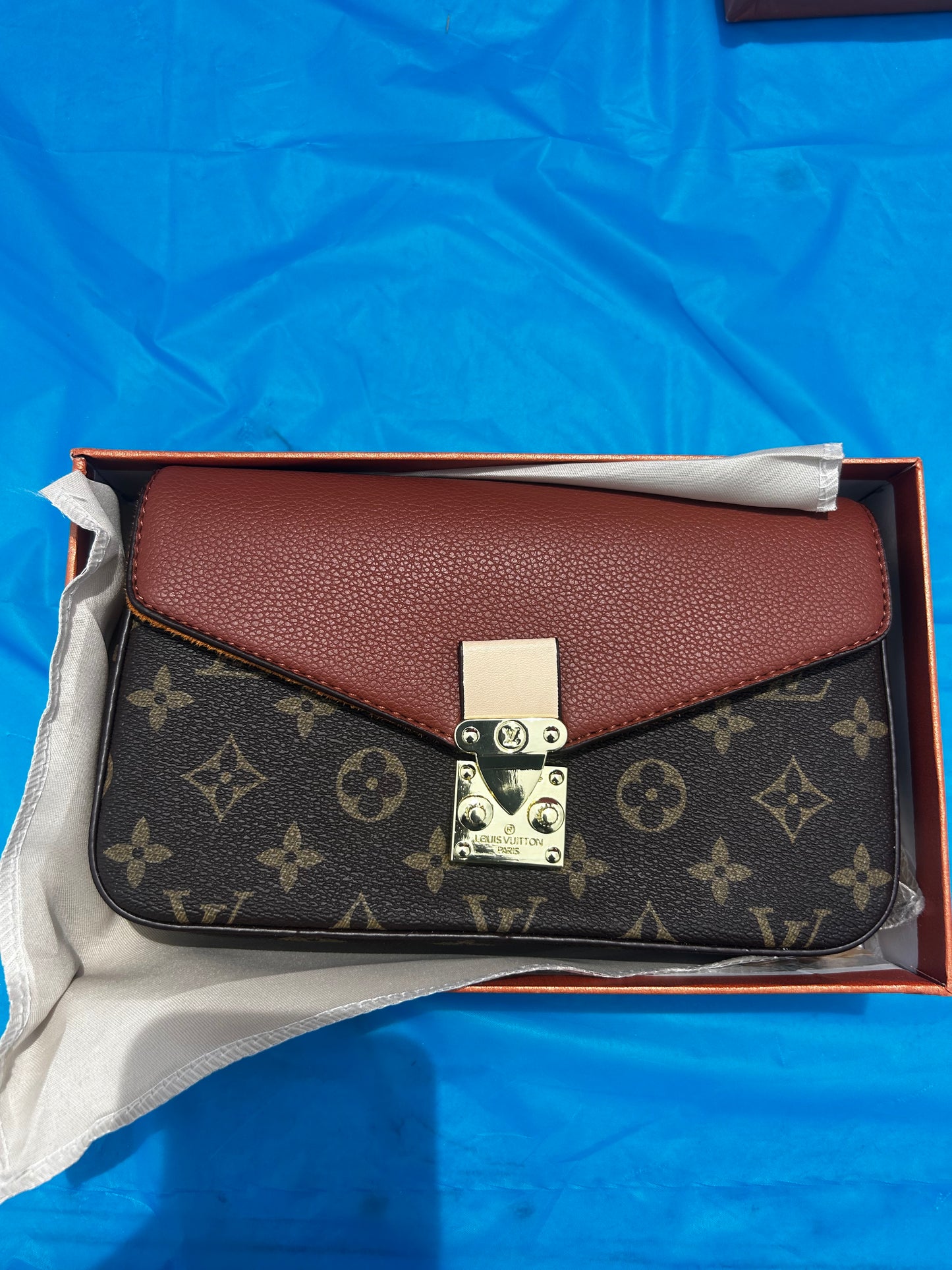 Louis Vuitton Pallas Chain Wallet featuring the classic monogram canvas paired with a cinnamon brown leather flap.