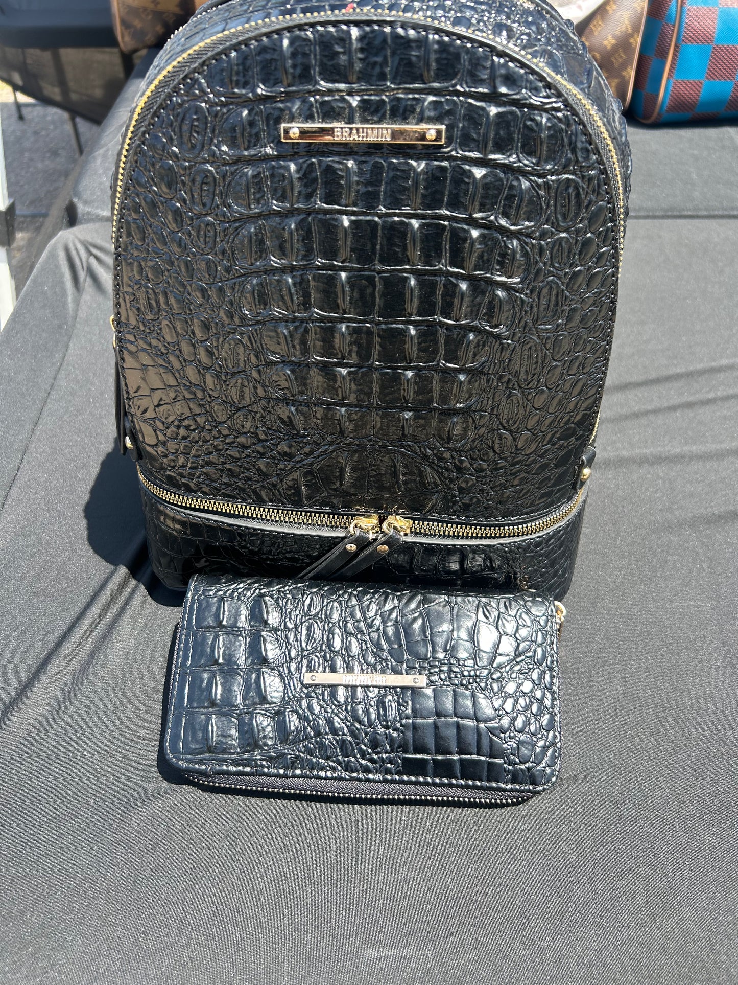 Brahmin Dartmouth backpack and matching wallet crafted from signature Black Melbourne croc-embossed leather