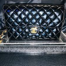 Chanel Classic Double Flap Bag in black caviar leather with gold-tone hardware with wallet