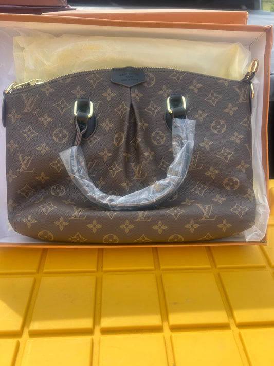 Louis Vuitton Boetie MM NM Monogram bag trimmed in black handles